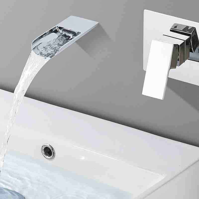 The wall mounted basin in the bathroom has a concealed embedded faucet